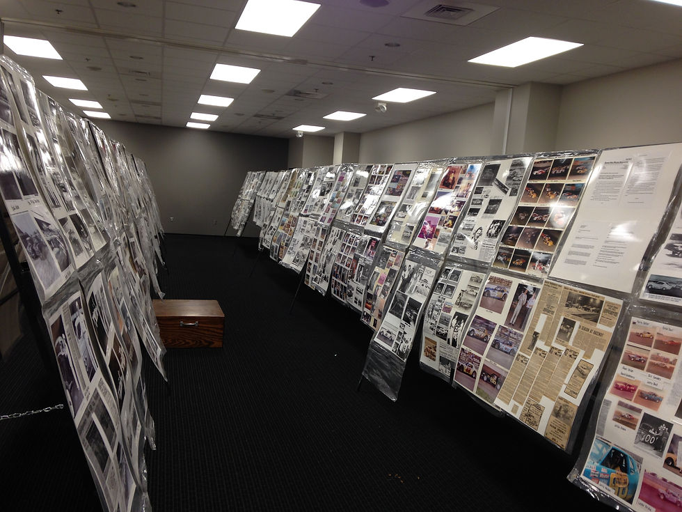 An exhibition of poster boards on display featuring photographs and ephemera from Ozarks racing history.