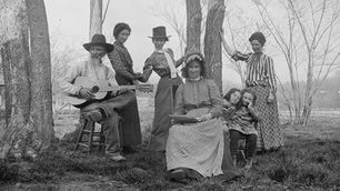 A black and white photograph of an early 20th century Ozarks family posed outside.