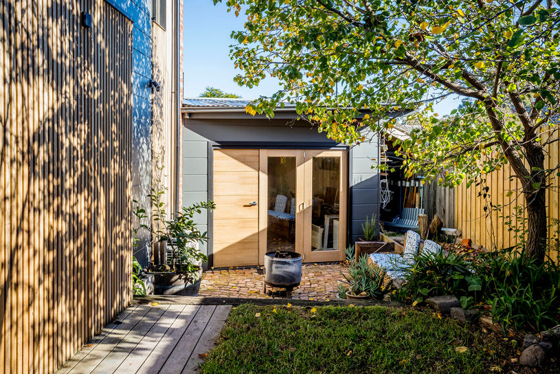 Landscaped courtyard framed by timber screening and the contemporary rear extension.