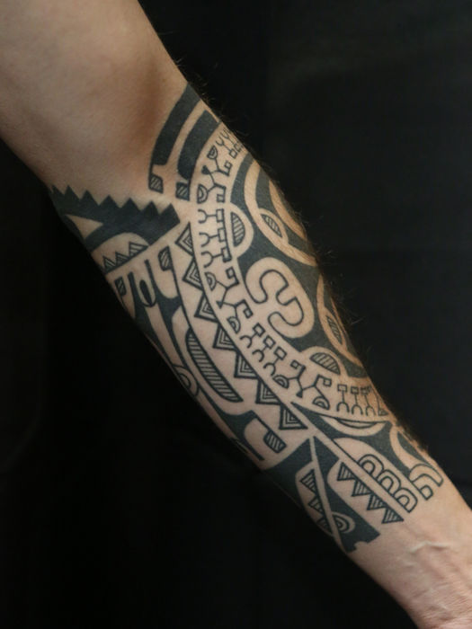Healed Marquesan tattoo
style Polynesian forearm tattoo sleeve with bold tribal designs, inked by King ‘Afa and inspired by the patutiki art of the Marquesas Islands of Nuku Hiva, Hiva Oa, and Fatu Hiva.