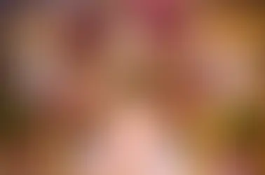 Lavishly decorated wedding aisle with floral arches, chandeliers, and vibrant flower arrangements.