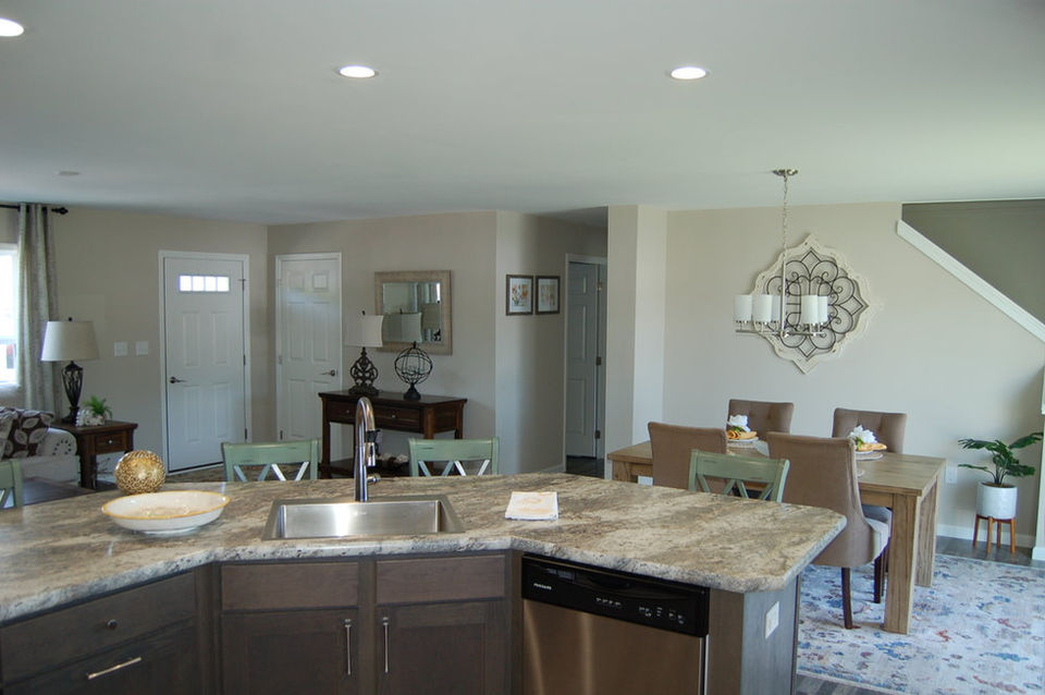 Dover Cape Photo From Behind Kitchen Island Looking Into Dining Room And Living Room. The Dover Cape Is A Pleasant Valley Homes Modular Home Built By Patriot Home Sales.