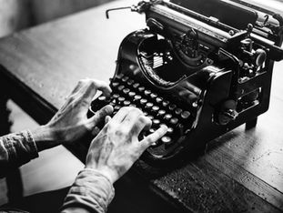 Typing on a typewriter.