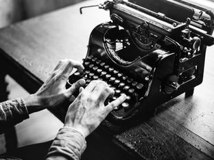 Typing on a typewriter.