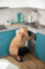 woman-calling-plumber-solve-kitchen-problems.jpg