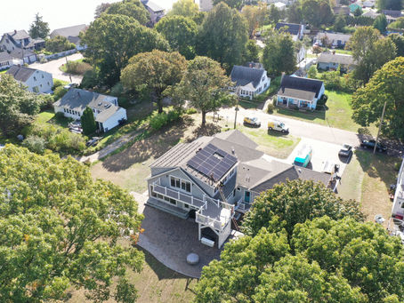 Aerial view of a Rhode Island home with rooftop solar panels installed by Newport Solar