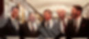 Five men in suits representing freemasons in a wood paneled room