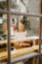 woman working through coffee shop window at Lost + Found cafe in Elora