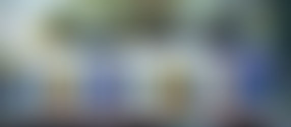 Modern prefabricated tiny house with sleek grey-and-white exterior, large windows, and timber deck — an example of affordable tiny homes in Australia.