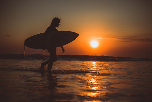 girl-posing-with-board-sunset.jpg
