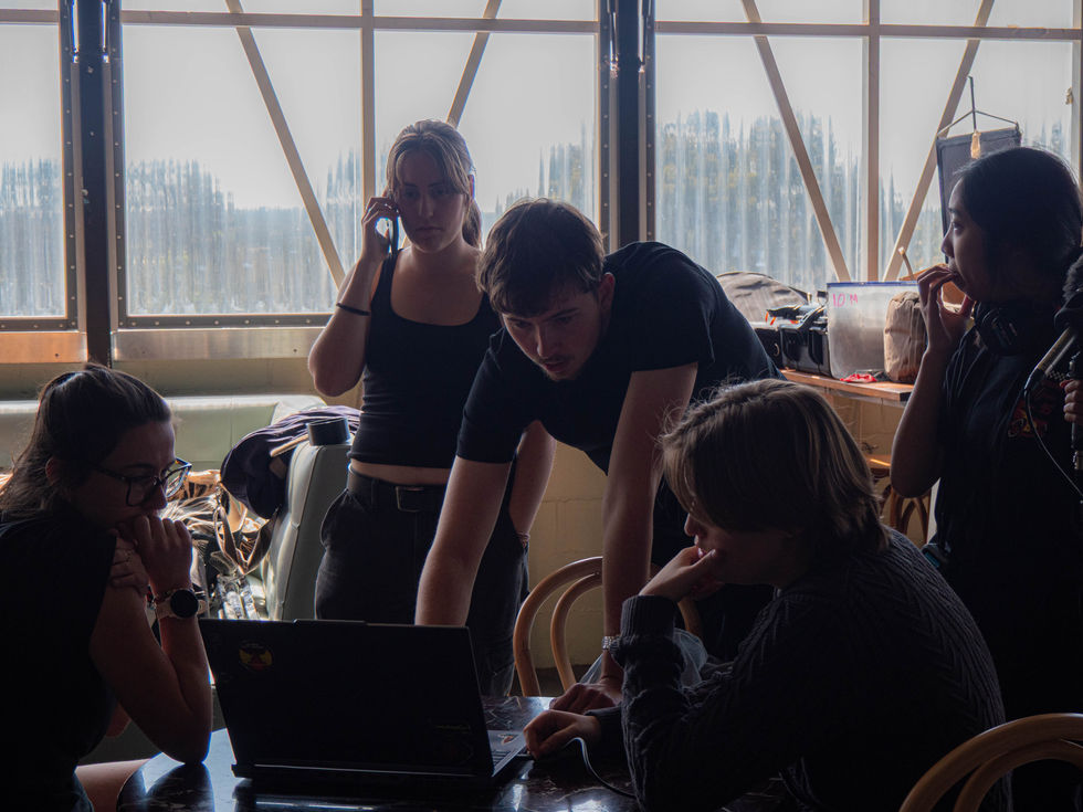 Group of students collaborating around a laptop, discussing the project. Various Projects as a Media Arts Student