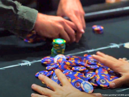 Person playing poker at Outlaws casino in Atascadero.
