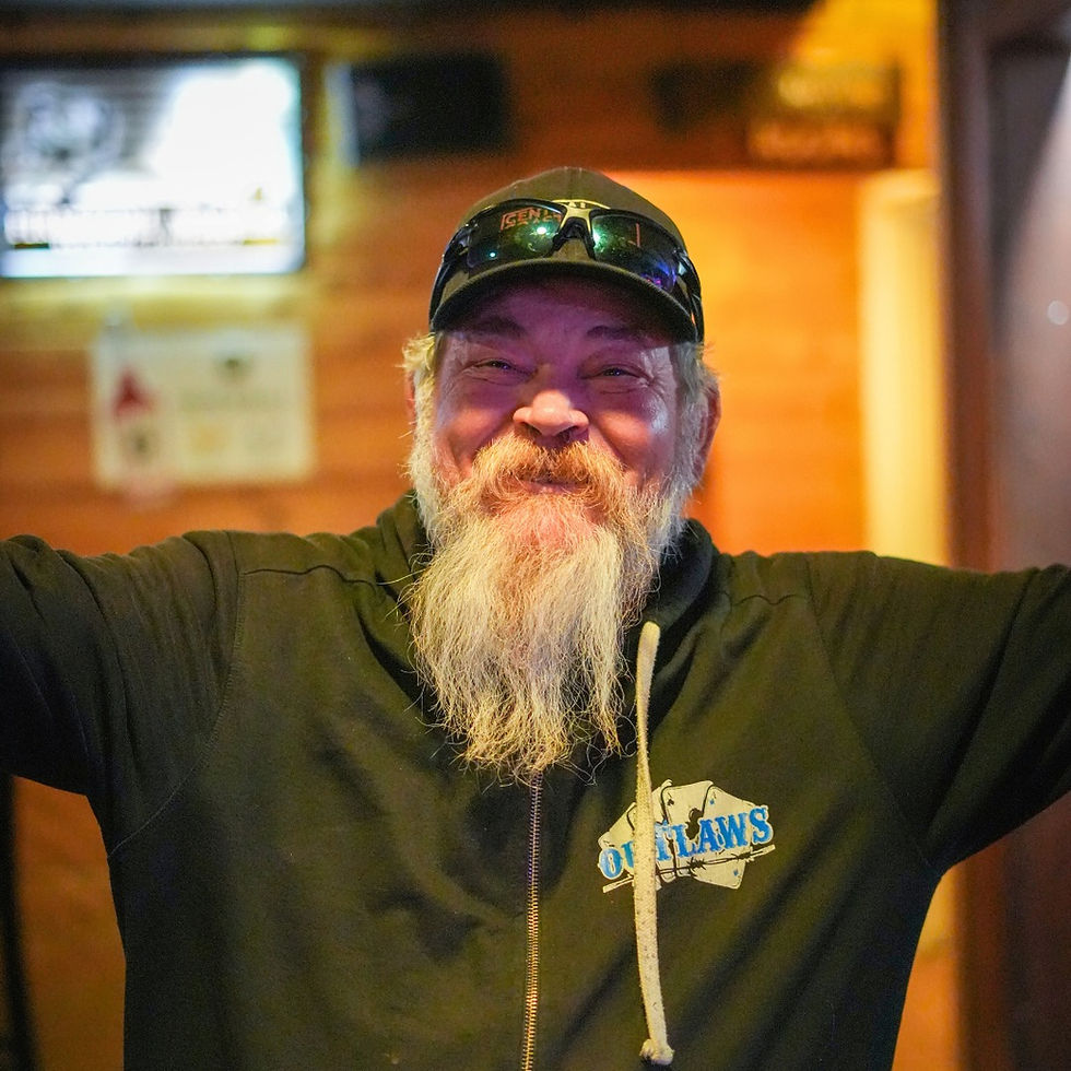 A man happy to be playing poker at Outlaws casino.