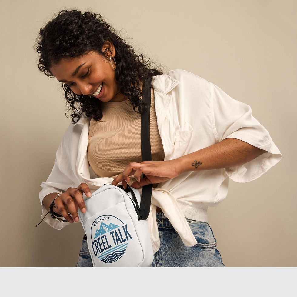 Thumbnail: Woman opening white 'CREEL TALK' cross-body bag