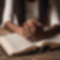 African American female praying hands on the bible.jpg