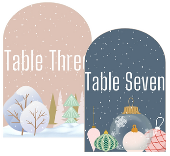 Arched shape with table number inside. Warm neutral and dark blue with winter pictures decorating it.