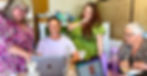 4 female business owners around a table smiling