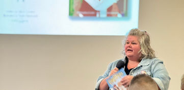 Tania speaking in front of an audience