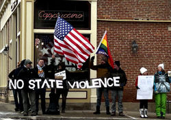 Protesters holding "No State Violence" Banner along with American Flag and Pride Flag