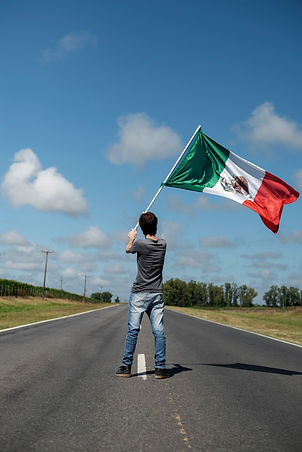 full-shot-man-holding-mexican-flag-street.jpg