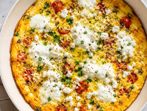 large pan with an egg frittata with tomatoes, salami, and burrata cheese
