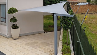 White poolside shade sail with custom steel supports