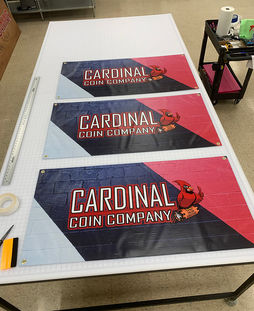 Custom vinyl banner production, grommet installation and finishing