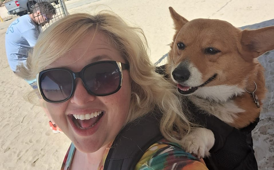 Rachael with her corgi at the beach