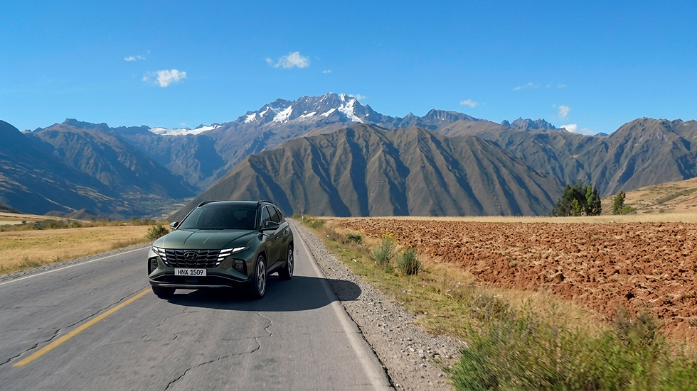 A premium luxury SUV descending through scenic Andean mountain roads during a Sacred Valley luxury private tour.