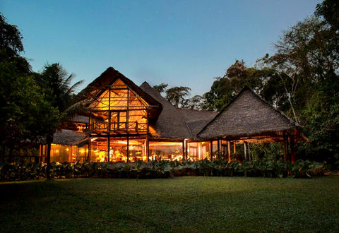 Luxury rainforest lodge in the Tambopata Reserve, Peru, surrounded by dense Amazon jungle and wildlife.