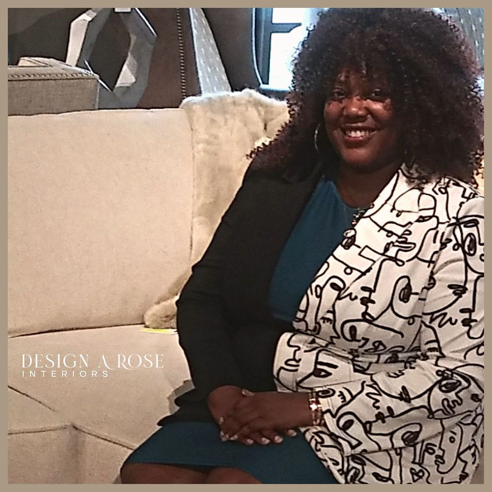 QuianaRose of Design A Rose Interiors in Chicago smiling on a large cream colored sectional sofa