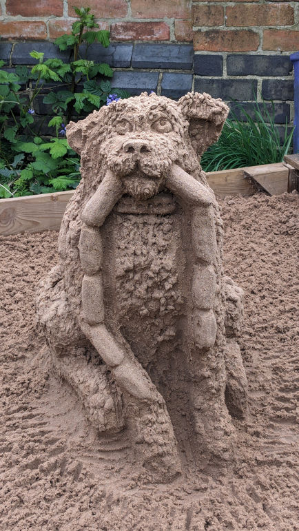The bad dog that stole the sausages - sculpted from sand in an urban sand pit