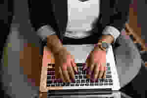 A person typing on a laptop