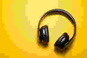 Pair of wireless headphones against a bright yellow backdrop