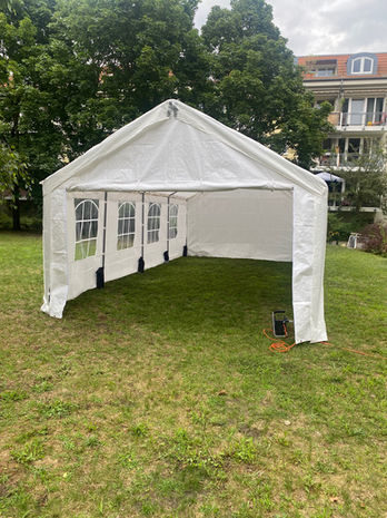 Weißes Partyzelt mit Bogenfenstern auf grüner Wiese in Berlin – Zeltvermietung für private und gewerbliche Veranstaltungen