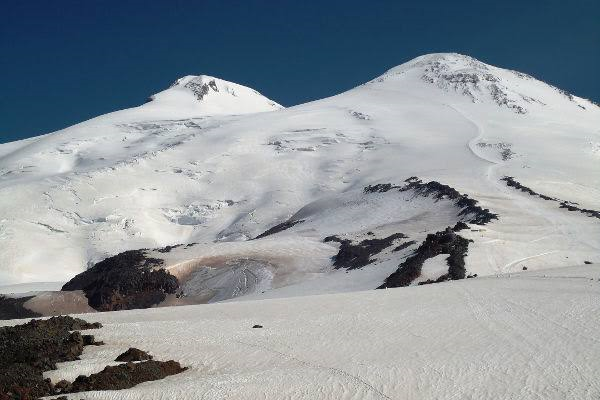 Eye-level view of climber with mountaineering gear on snowy slope