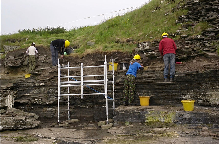 Cleaning and sampling of the erosion face of the broch at South Howe, Rousay