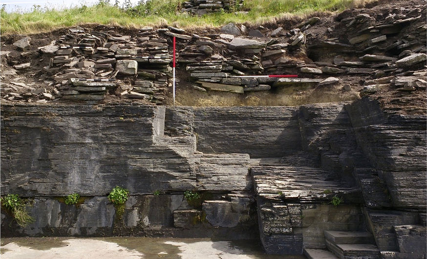 Bedrock below and eroding Iron Age buildings at South Howe, Rousay, destroyed by coastal erosion