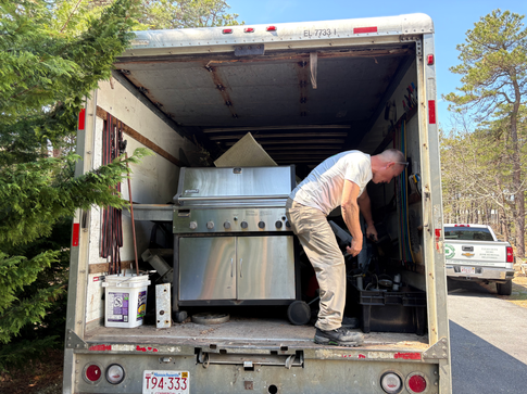 Crew member with a gill in the back of a box truck