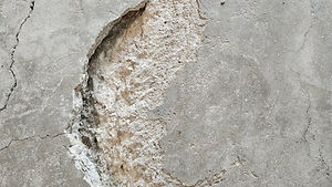 Crack and spall repair on garage concrete before coating