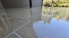 Tile-pattern concrete overlay patio with a high-gloss sealer in Columbia, MO