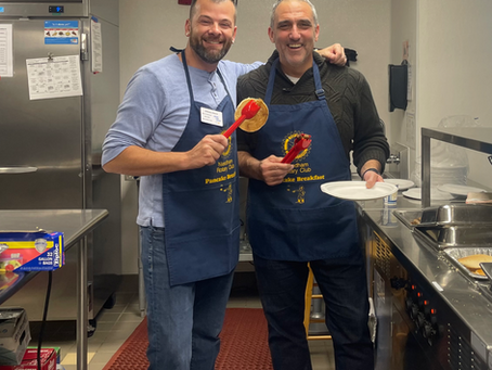 Two men cooking at the Rotary Needham Pancake Breakfast