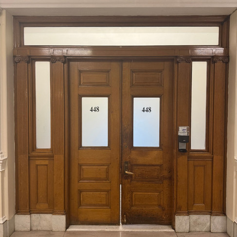 Walnut stained doors with the number 448 on frosted glass window