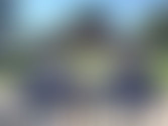 Three people smiling and holding Evan Francis signs.