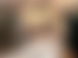 Group of people standing around a table in an auditorium talking