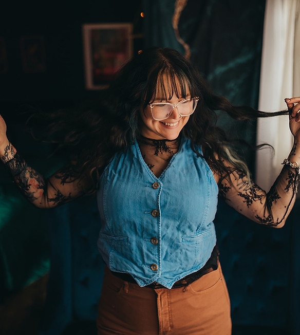 Smiling woman playfully tugging hair, unhinged homemaker.
