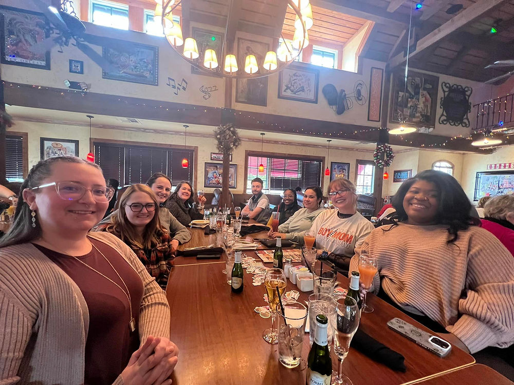 Diverse group smiling at a book club social