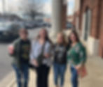 Four women friends smiling, a Book Club gathering