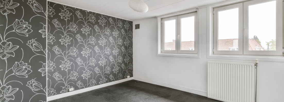 Wallpapered wall being prepared for careful stripping and redecoration