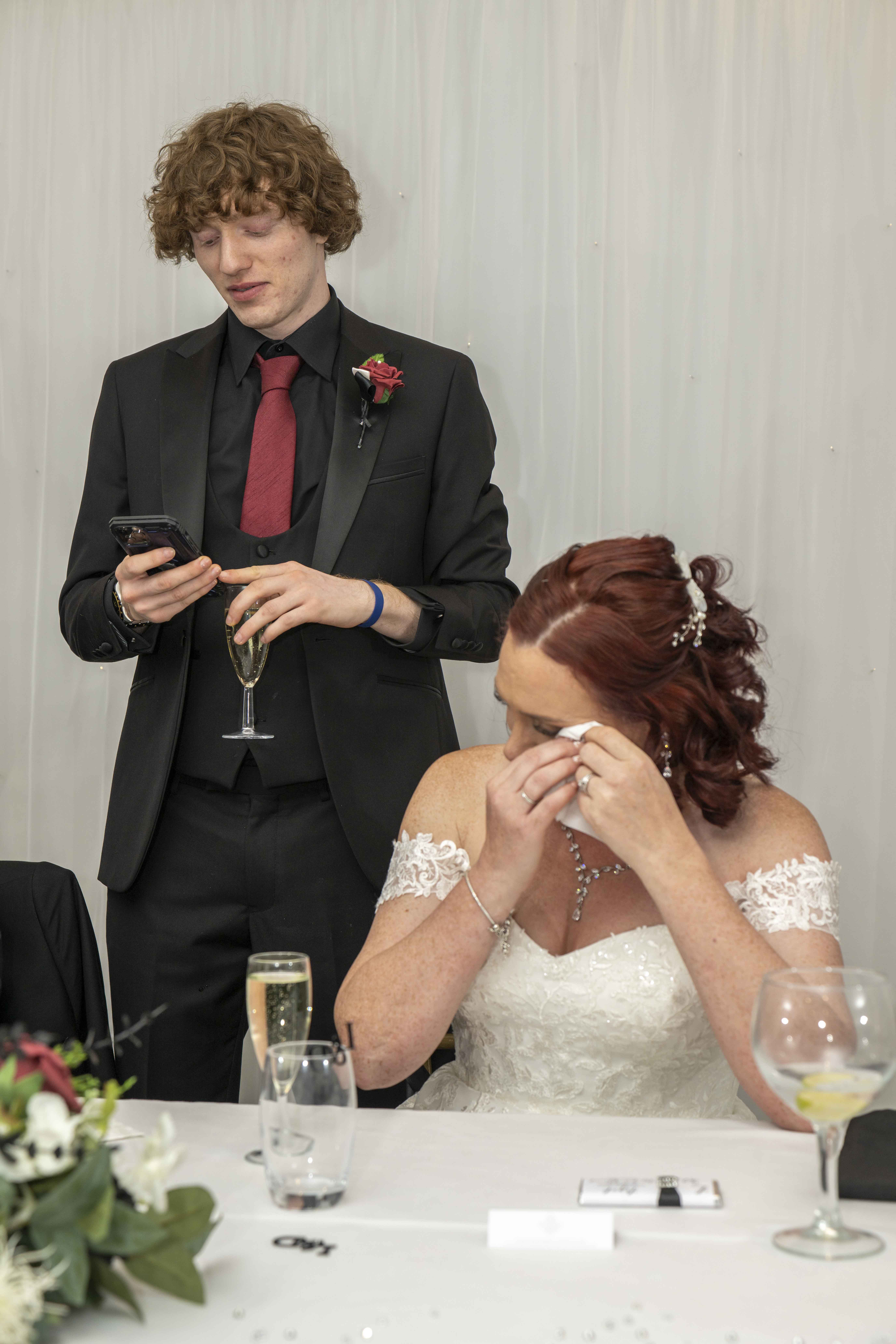 Parents and an engaged couple calmly discussing wedding photography package options